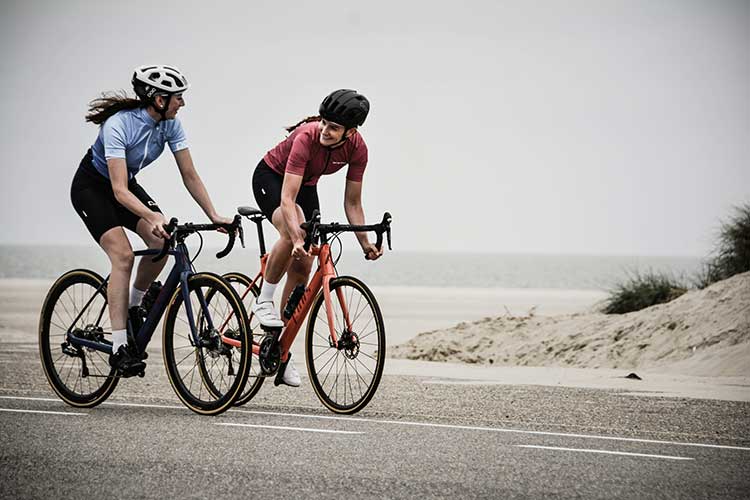 Two people on the ride together, laughing, as they decided that cycling with friends is the way to go